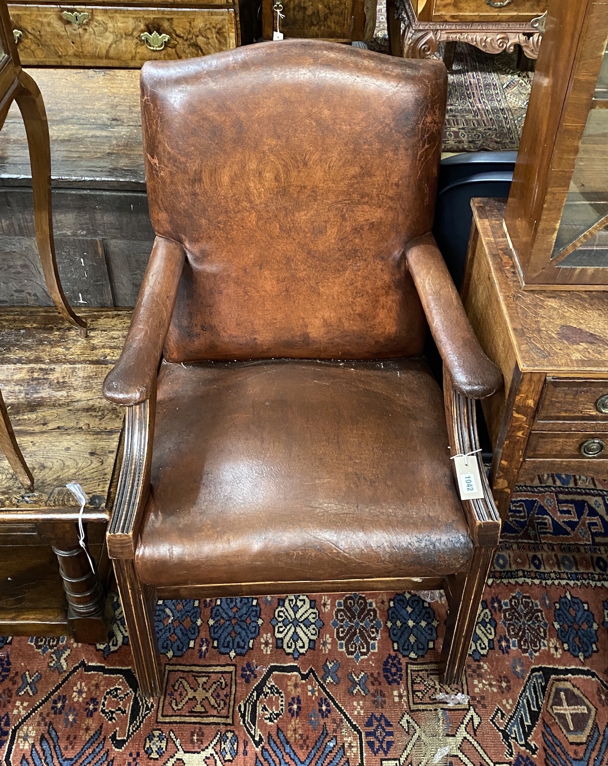 A George III style tan leather beech Gainsborough style chair, width 60cm, depth 56cm, height 95cm